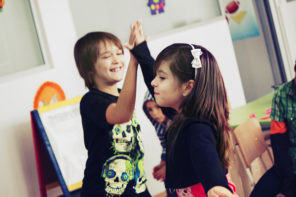 Two children showing team play